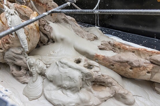 Mire Lee, As we lay dying, 2022, casting clay, unfired clay, fired clay, pump, water spray, rebars and other mixed media.